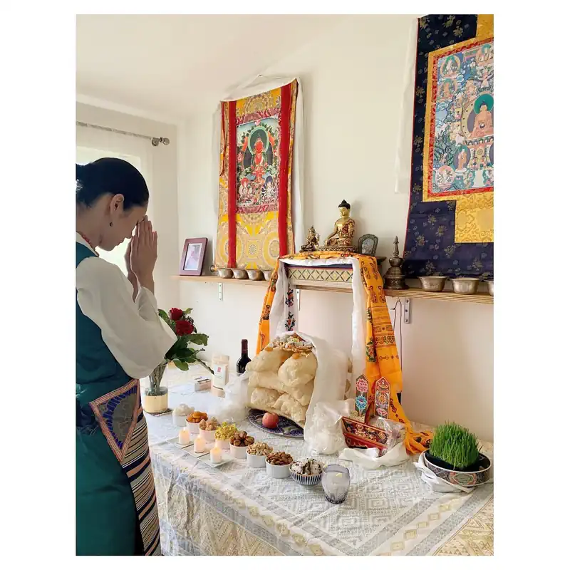 Photo of Buddhist Tao Okamoto praying to the idol of Lord Buddha