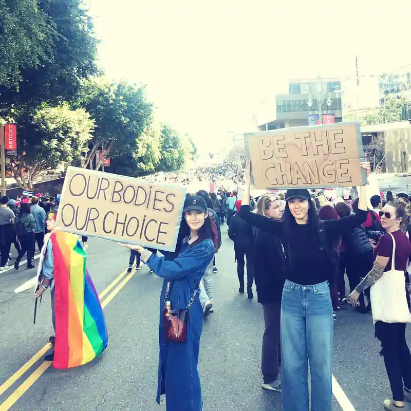Tao Okamoto's photo at a pro-choice rally where she is raising a poster that said, "Our bodies, our choice"