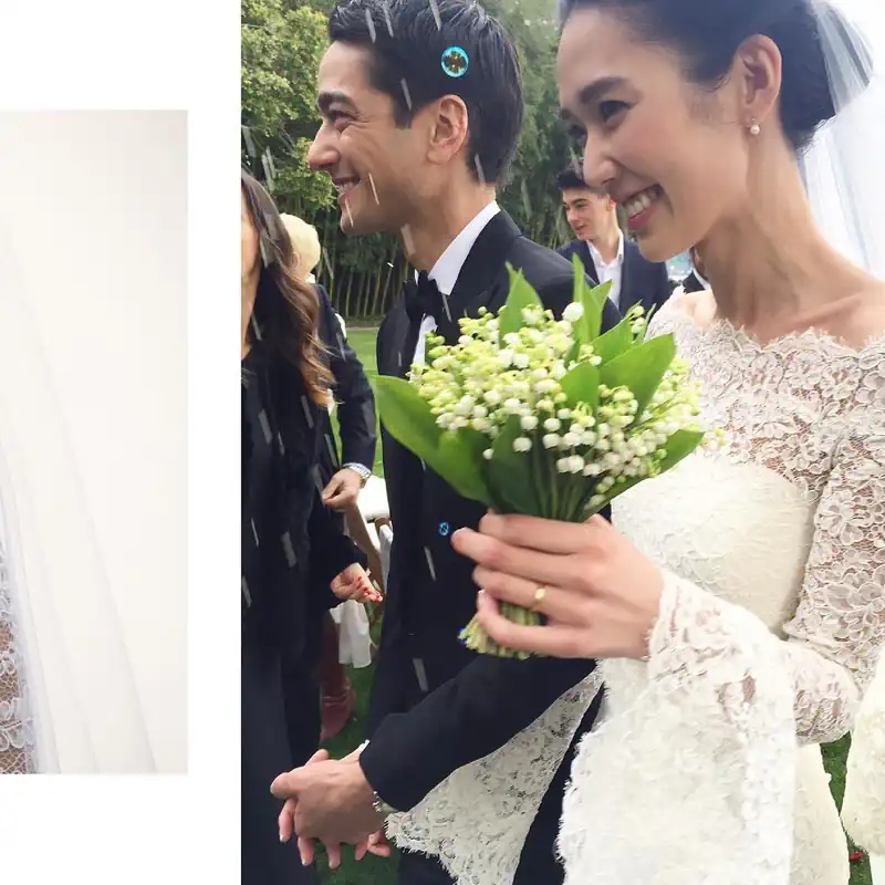 Tao Okamoto in her wedding dress standing alongside her husband Tenzin Wild